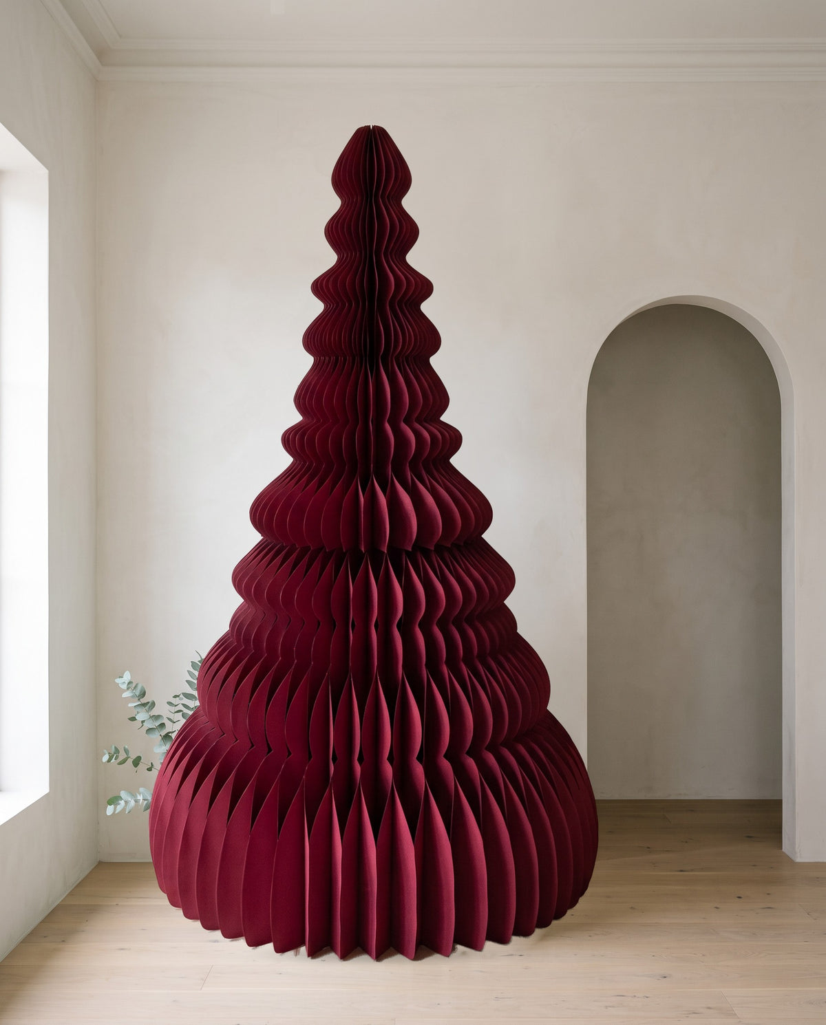 Élan paper Christmas tree, 240cm, in Burgundy, in a white room beside an arched doorway