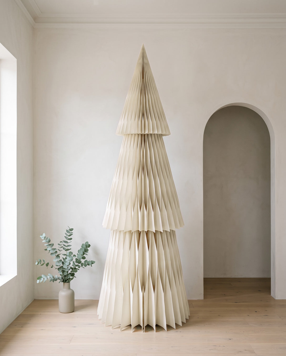 Forma paper Christmas tree, 240cm, in Off white, in a white room beside an arched doorway