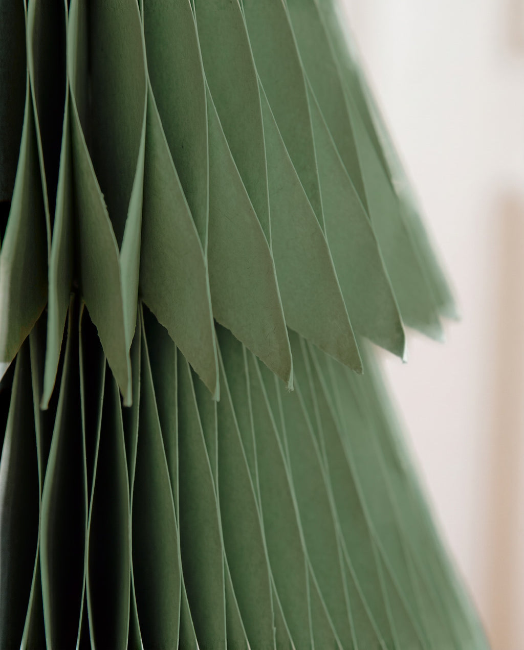 Close-up of the pleated paper and the fringed edge of a tier on a Sage Forma tree