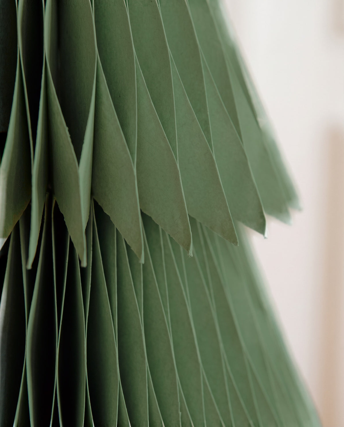 Close-up of the pleated paper and the fringed edge of a tier on a Sage Forma tree